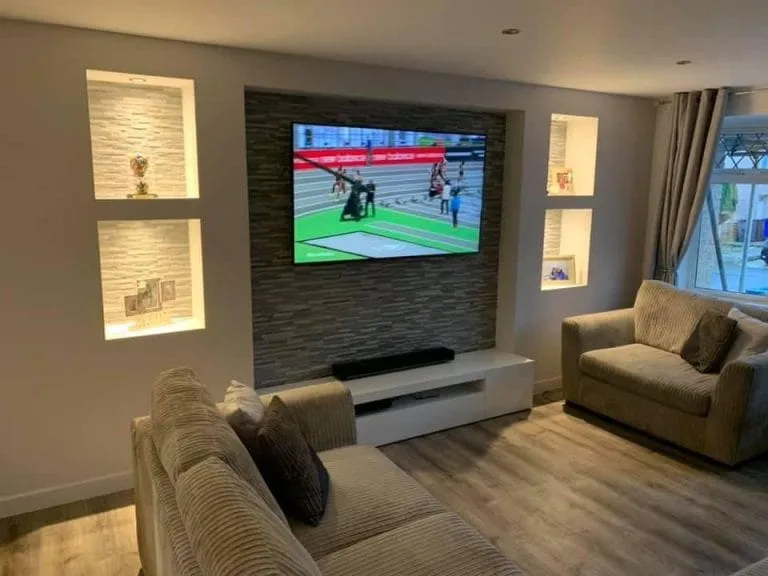 Completed plastered media wall with fireplace and TV