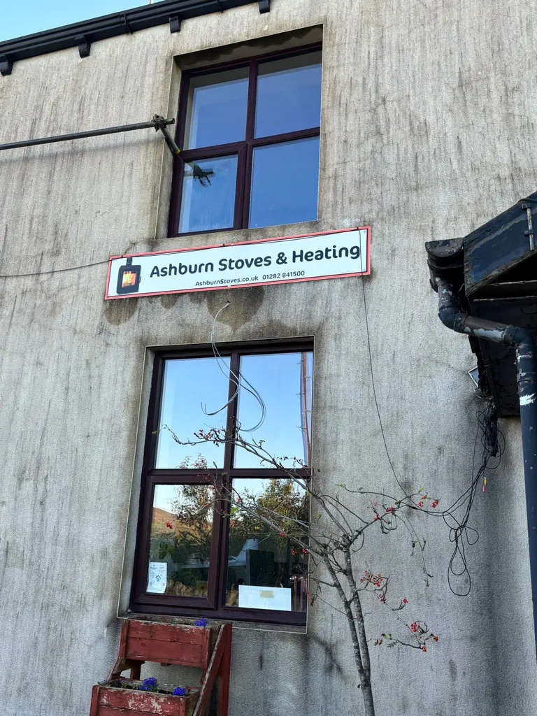 Two-storey render covered in black algae streaks and grime before cleaning